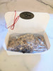 Open Box of Almond Butter Toffee red bow and gold seal